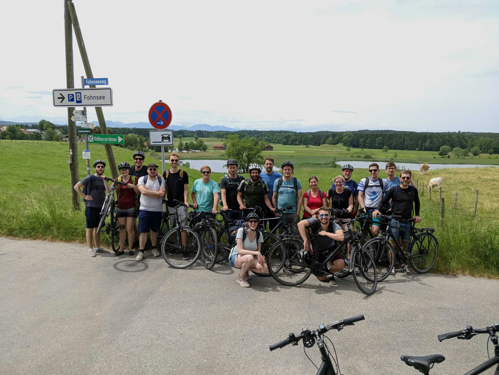 The peerigon team, proudly posing behind their bikes in front of an alpine background